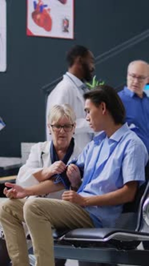 Doctor Measures Patient's Blood Pressure in Hospital