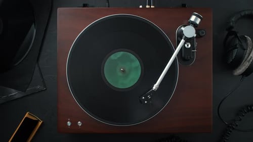 Vinyl Record Spinning in Slow Motion on a Stylish Turntable Standing on a Table - Top View.