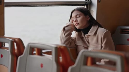 Contemplative Young Woman Traveling Alone on Ferry