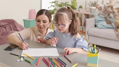 Woman and Child Drawing at Home Together