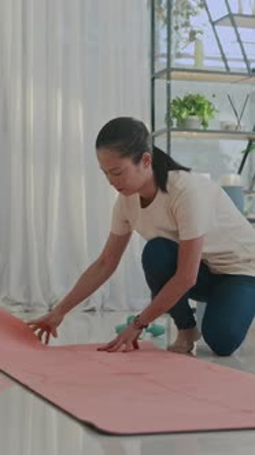 Sportswoman Preparing for Training on Mat Indoors