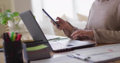 Woman Working at Home Typing on Laptop