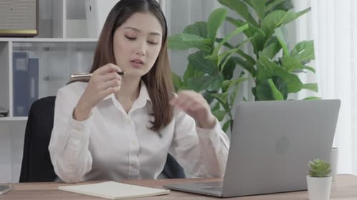 Enthusiastic businesswoman working and typing laptop in the office.