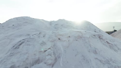Aerial View of Industrial Material Piles Under Sunlight