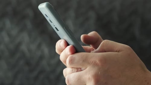 Hands Holding Phone and Tapping Screen