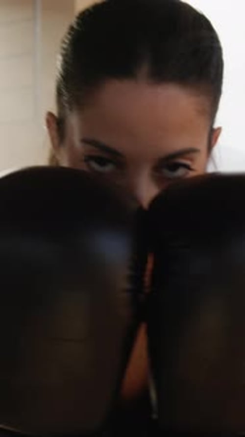 Woman with Boxing Gloves in Fighting Stance