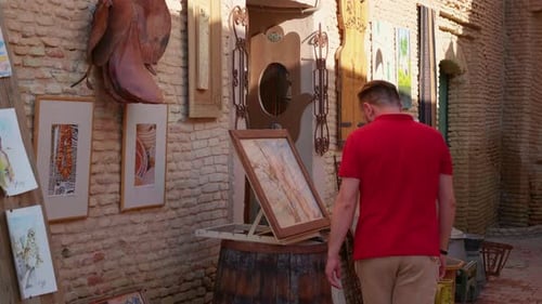 Tourist man on street market looking for souvenirs from Tozeur.