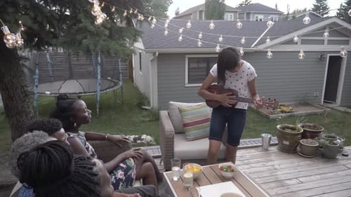 Friends Gather on Deck with Ukulele Music