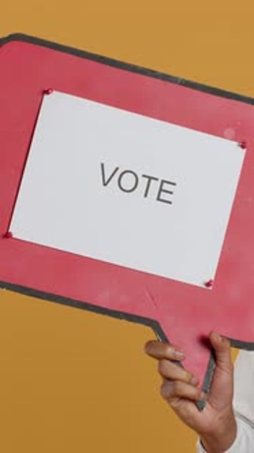 Hand Holding Vote Sign