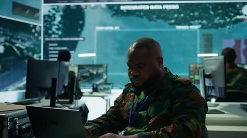 Man Works on Laptop in Futuristic Office