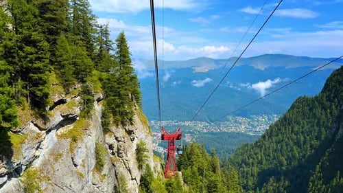 Cable car view over a mountain valley town.