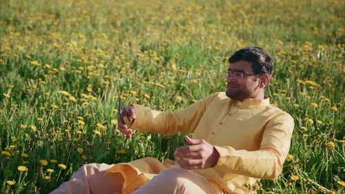 Indian Man Relaxing in a Dandelion Field