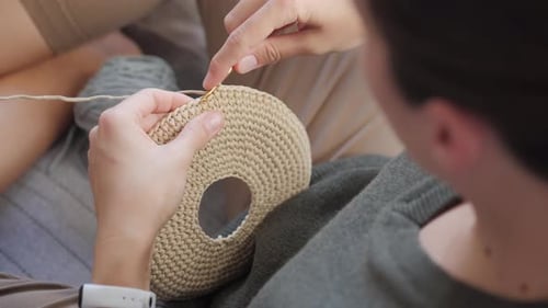 Person Crocheting Yarn Project With Hook