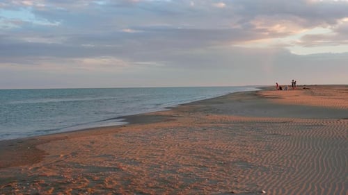 Happy beach holidays concept. Blurry defocused family of three persons walking in distance on sandy