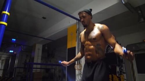 Strong African Athlete with Tattoos Skipping with a Jump Rope at Sport Club Young Black Sporty Man