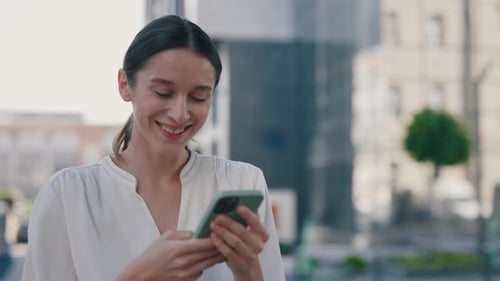 Smiling Businesswoman Using Smartphone Standing Near Modern Office Building Lady Looking at the