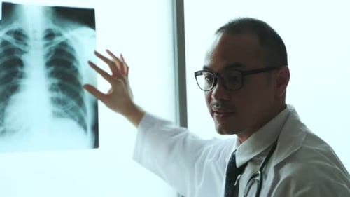 Medical Professional Examines Chest X-Ray in Hospital