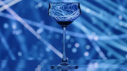 Clear Wine Glass Standing Infront of a Falling Rain Like Pattern in the Background