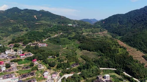 Take in the Scenic Aerial View That Showcases Lush Green Hills and Beautiful Villages Media
