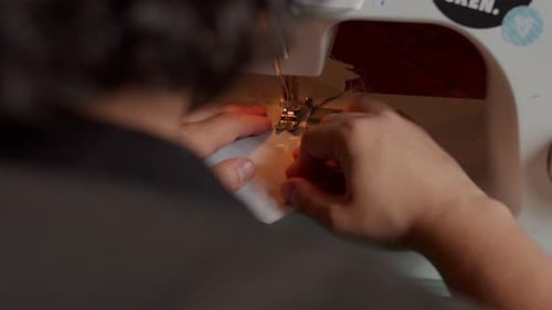 Person Using Sewing Machine for Needlework