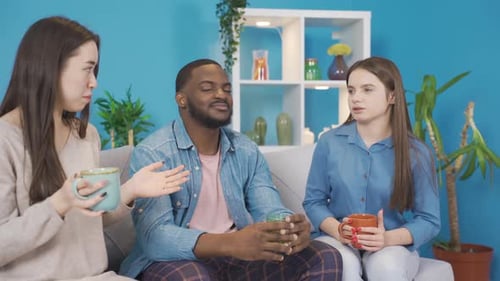 Three Friends Talking and Drinking at Home