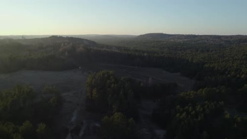 Drone flying backwards revealing huge European royal castle in forest