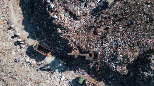 Large Waste Dump and Trash Truck with Garbage in Aerial Top View