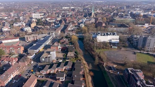High-angle aerial view of a European town featuring a canal, residential districts modern apartments