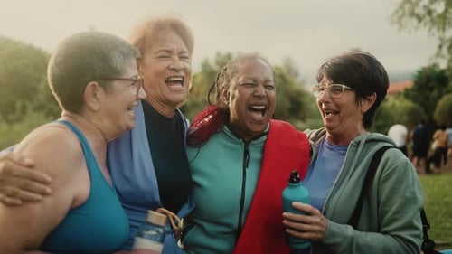 Happy multiracial senior women having fun after workout exercises in the park