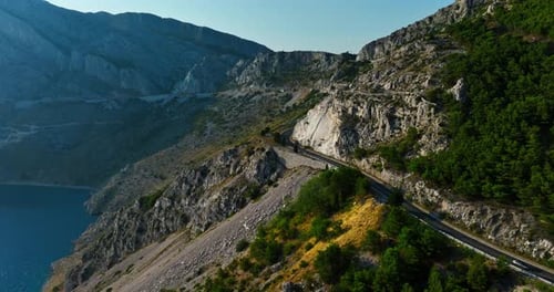 Drone following a mountainous road on the Makarska riviera, sunny day in Croatia