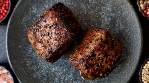 Succulent Grilled Beef Steaks Garnished with Herbs and Spices