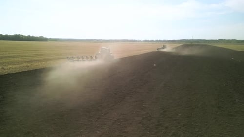 Tractors plowing the field in Ukraine