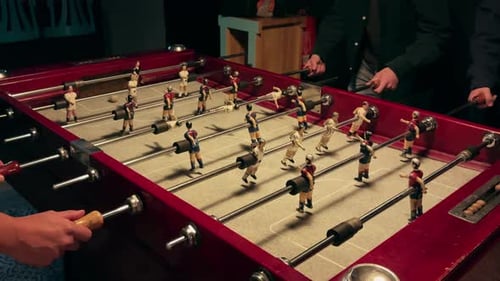 People Playing in Table Football or Kicker with Miniature Players Table Football Game Employees