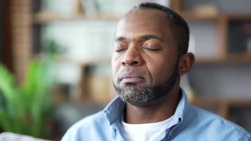 Man Meditating Indoors Close Up