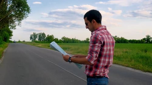 Man with Map on Rural Road Points