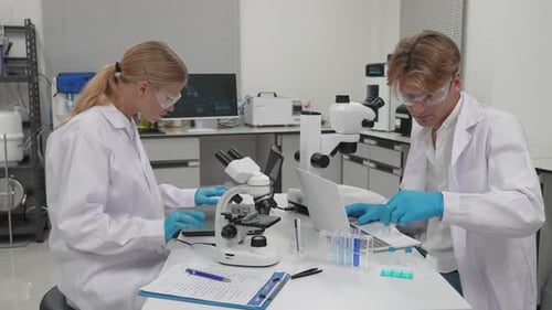 Scientists Researching and Analyzing Data in Laboratory