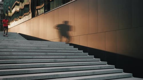 Young Adult Running Down Urban Staircase