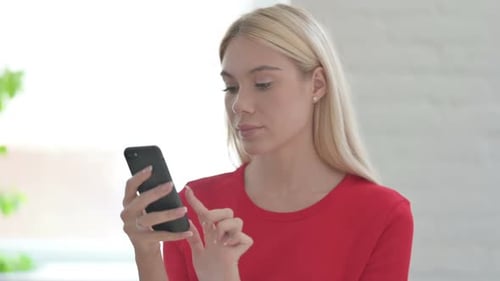 Young Woman Using Smartphone Indoors in the Daytime
