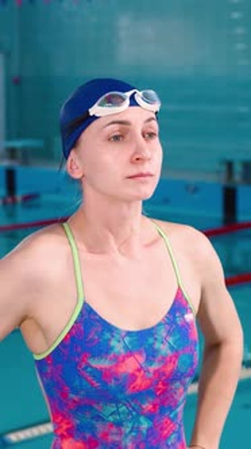 Woman Adjusting Goggles at Indoor Swimming Pool