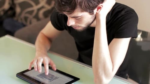 Male college student using tablet computer