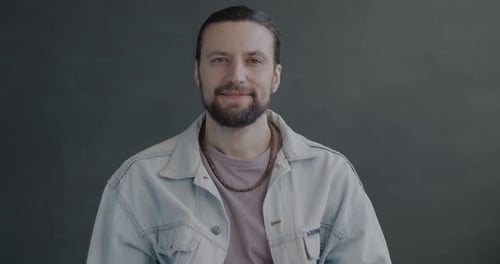 Smiling Man Gives Okay Sign to Camera