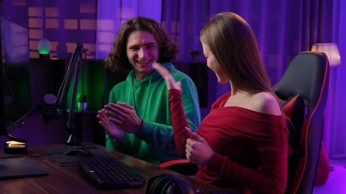 Young Adults Celebrating Success in Home Gaming Setup