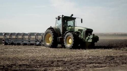 Tractors plowing the field in Ukraine