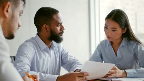 Collaborative Business Meeting in Modern Office Setting Discussing Strategies