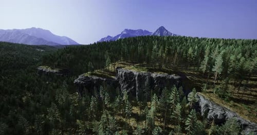 Majestic Mountains Rise Above a Lush Green Forest Under a Clear Blue Sky