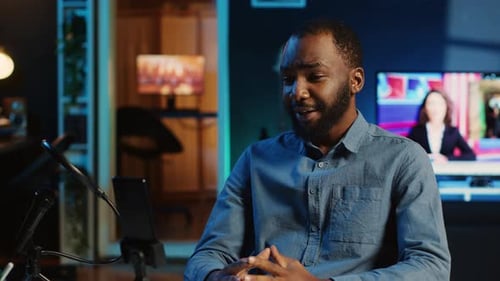 Man Talking to Broadcast Audience at Home