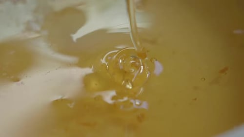 Golden Honey Pouring for Sweet Natural Food Preparation