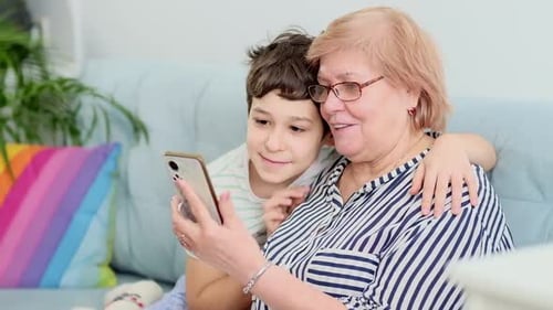 Senior Woman and Child Using a Cell Phone