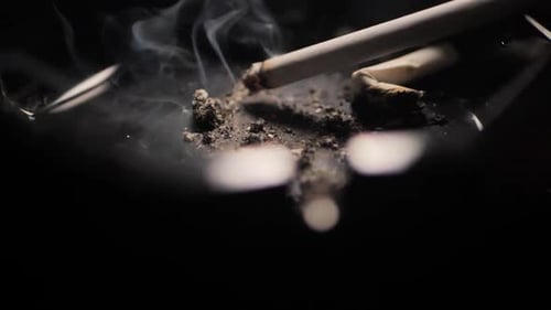 Close up smoking cigarette on man hand. Slowmotion. Scene J.