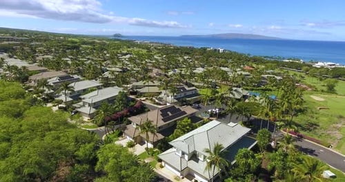 Paradise holiday resort on tropical islands surrounded by deep blue ocean under a bright blue sky wi